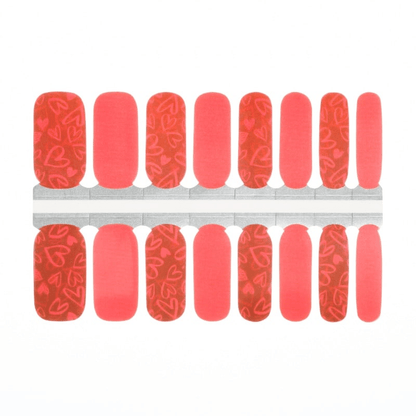 Coral and red heart pattern nail wraps with romantic rose designs for Valentine's Day manicure