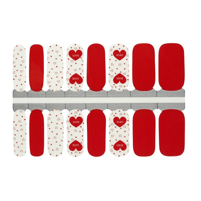 Red and white nail wraps with heart patterns and polka dots for Valentine's day manicure
