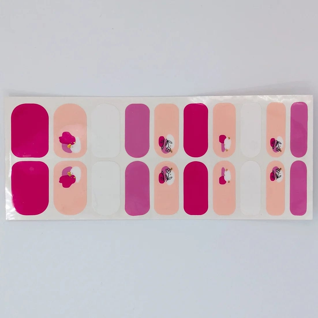 Three sheets of wide fit nail wraps in magenta pink with rose floral patterns
