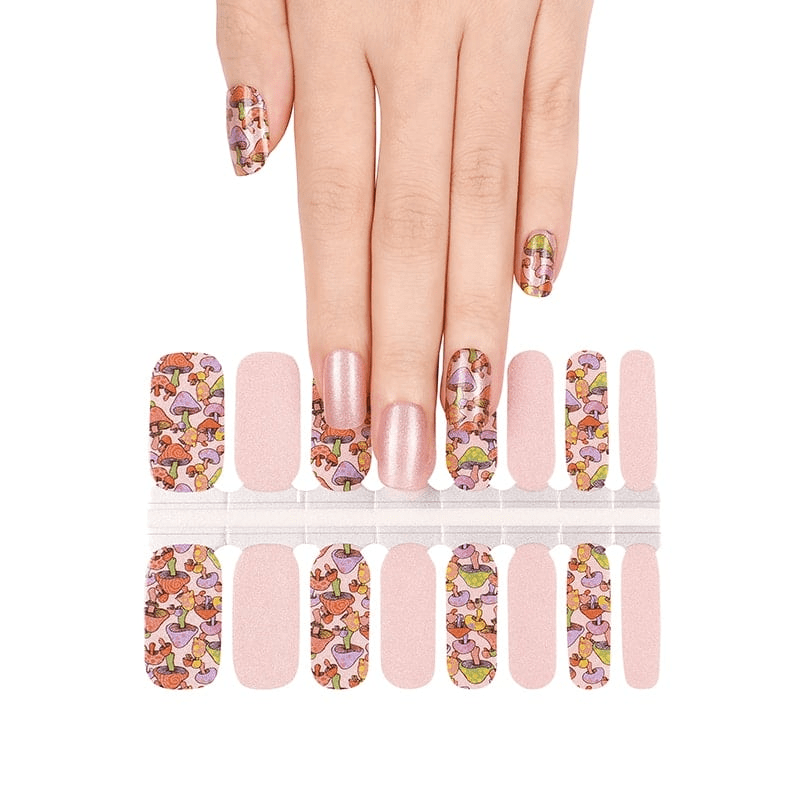 Whimsical mushroom nail wraps with pink base and enchanted fairytale illustrations
