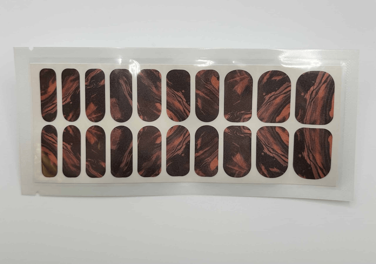 Wide fit nail wraps sheet with abstract marble pattern in orange black burnt tones