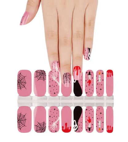 Halloween nail wrap sheet showing pink ghost designs, spider webs and red drip patterns