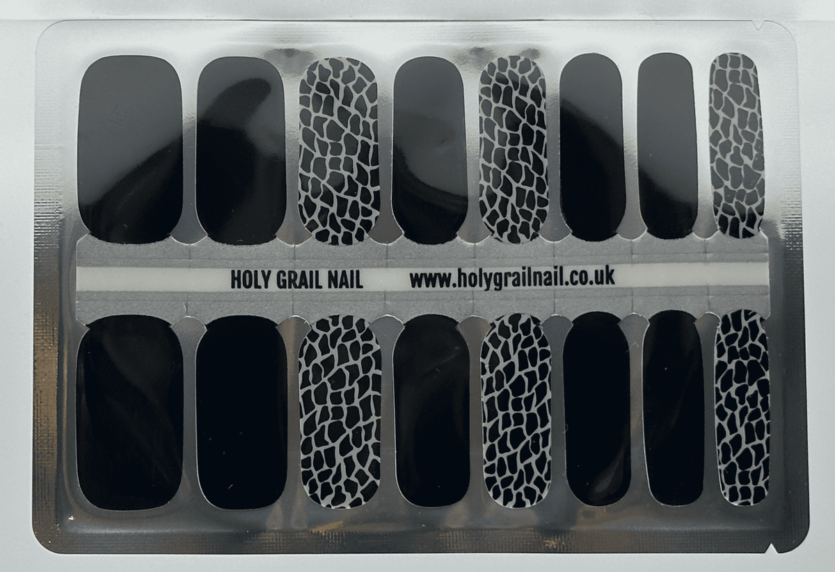 Black and white giraffe print nail wraps with glossy solid black accent nails