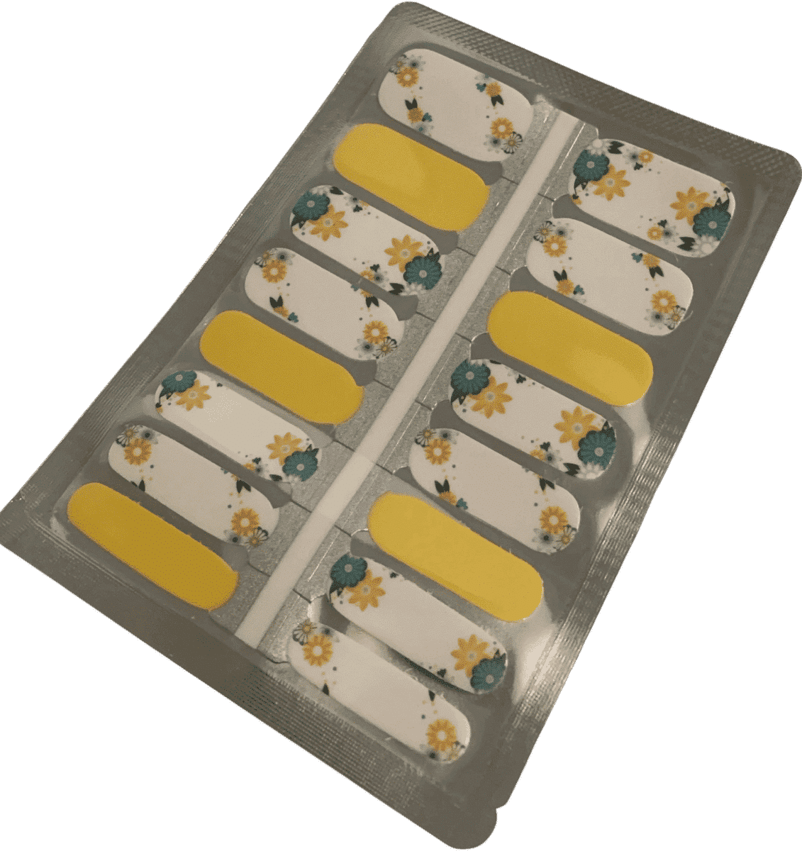 Yellow and white daisy floral nail wraps with sage green leaves in packaging