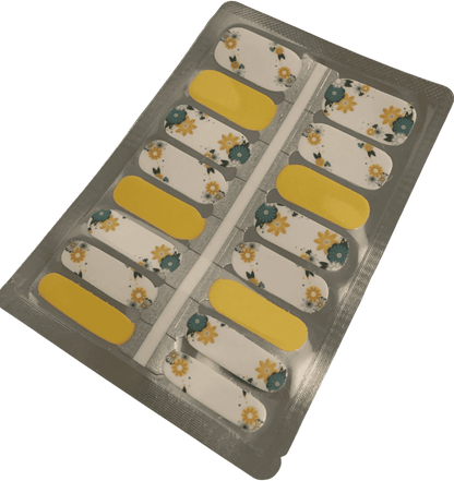 Yellow and white daisy floral nail wraps with sage green leaves in packaging