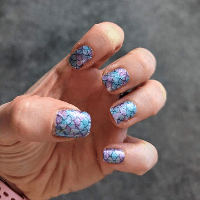 Holy Classics nail wraps with blue and purple mermaid scale pattern on short nails