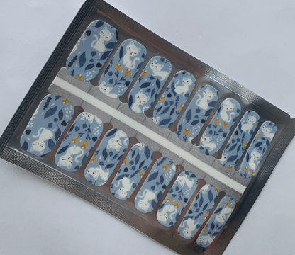 Blue non-UV nail wraps with white cats and flowers in packaging sheet