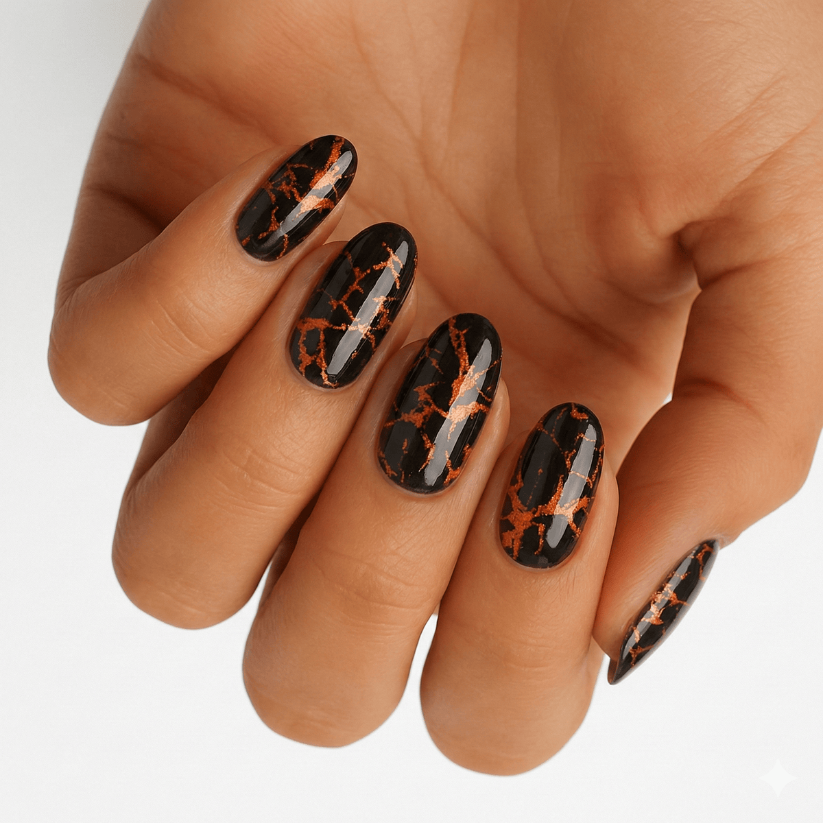 Black marble non-UV nail wraps with copper bronze metallic veining on hand