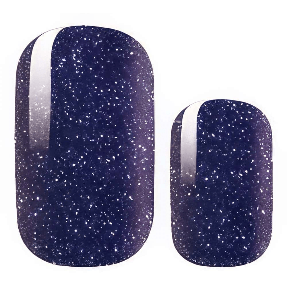 Navy blue nail wraps with white speckled glitter and a silver metallic side stripe accent.