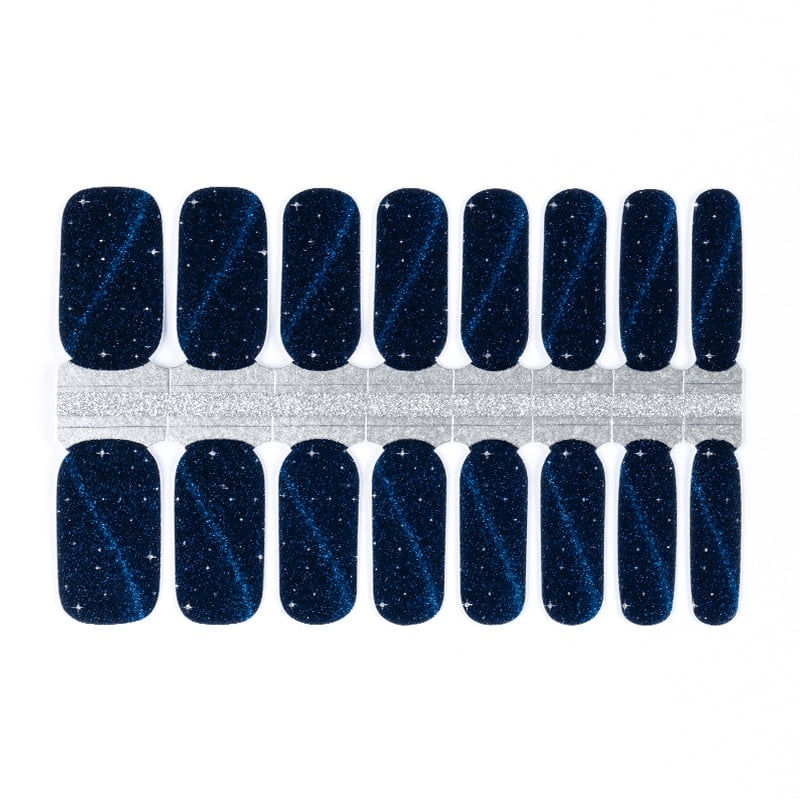 Navy blue nail wraps with shimmering cat-eye glitter effect and star-like sparkles