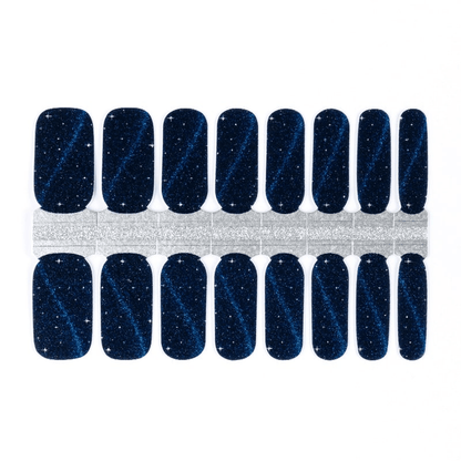 Navy blue nail wraps with shimmering cat-eye glitter effect and star-like sparkles