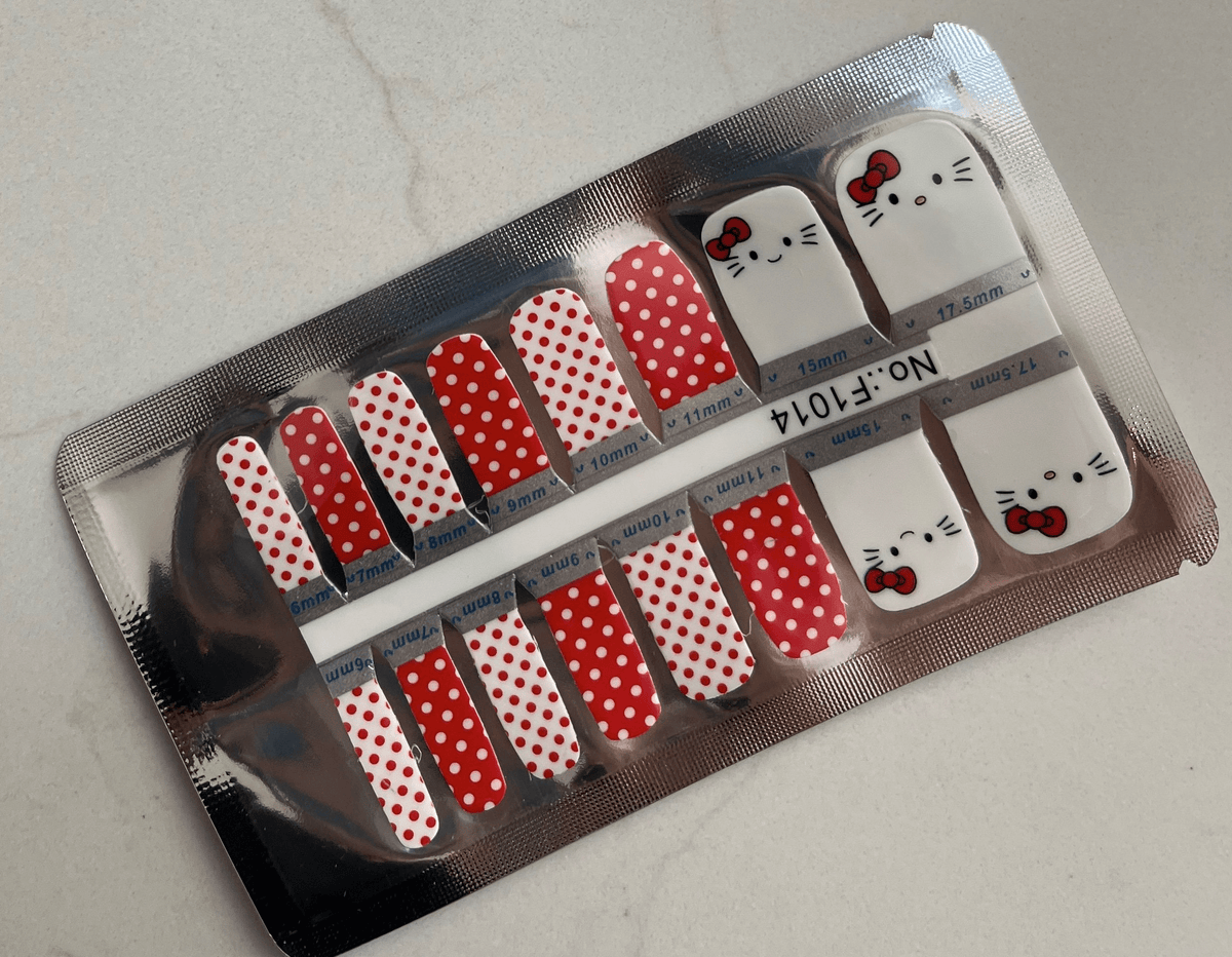 Non-UV pedicure nail wraps in red polka dot pattern with Hello Kitty designs