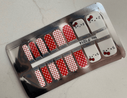 Non-UV pedicure nail wraps in red polka dot pattern with Hello Kitty designs