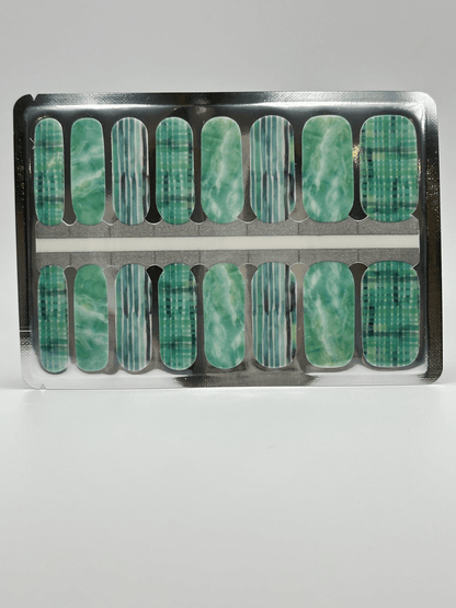 Mint green nail wraps with striped and watercolour patterns in packaging