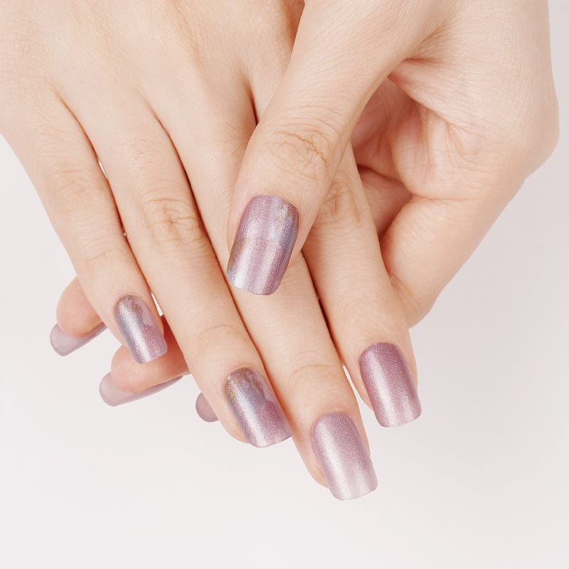 Pink shimmer nail wraps on hand showing elegant pearl finish manicure