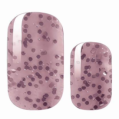 Mauve pink nail wraps with scattered dark purple dots in abstract speckled pattern