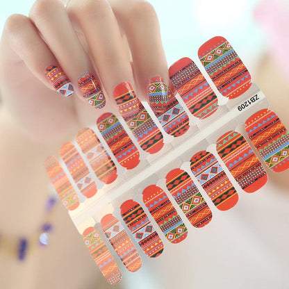 Sheet of red orange tribal geometric nail wraps with southwestern bohemian patterns for at-home manicure