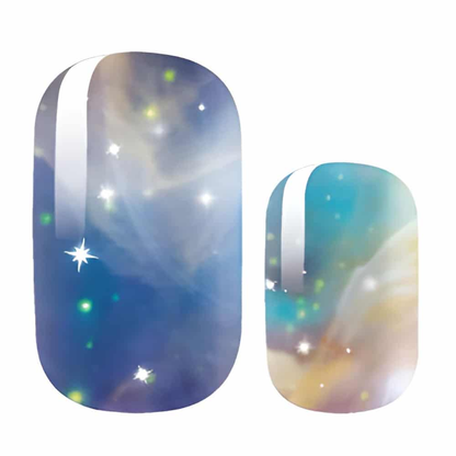 Blue and gold galaxy-print nail wraps with silver streak and star sparkles
