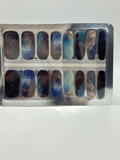 Galaxy nebula nail wraps set showing blue cosmic patterns with glitter stars packaging