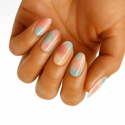 Hand displaying pastel pink and mint green marble nail wraps with soft watercolour finish