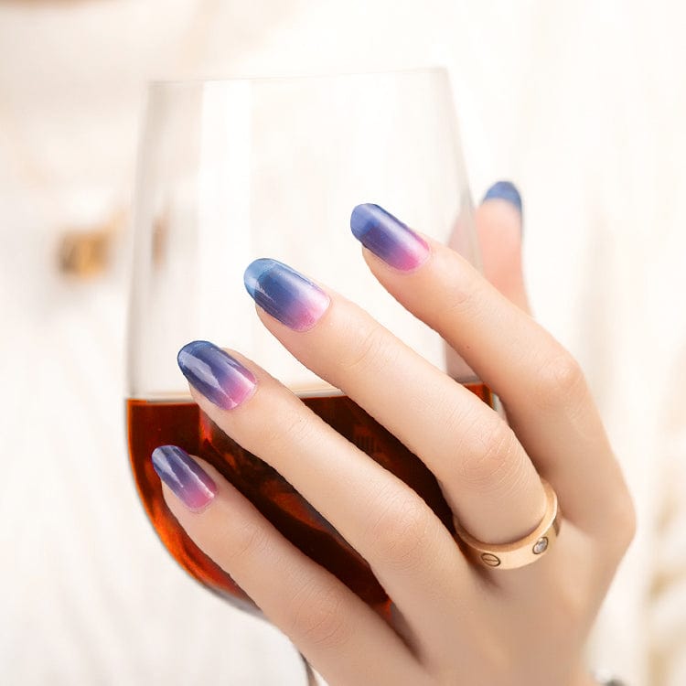 Elegant hand displaying blue pink ombre nail wraps with smooth colour transition gradient