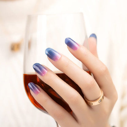Elegant hand displaying blue pink ombre nail wraps with smooth colour transition gradient