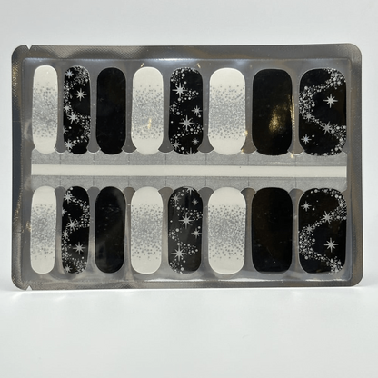 Black and white nail wraps with silver glitter, star accents and constellation motifs