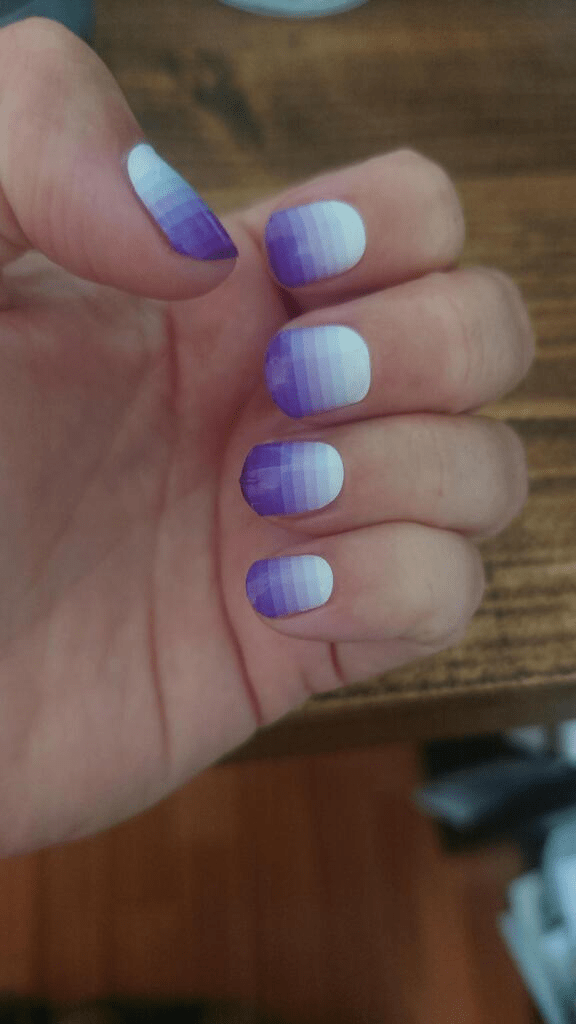 Nail wraps in purple-to-white ombré gradient with glossy finish, short round nails