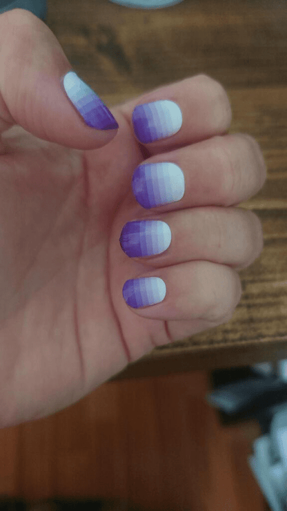 Nail wraps in purple-to-white ombré gradient with glossy finish, short round nails