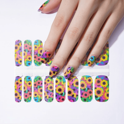 Hand wearing colourful sunflower nail wraps with vibrant floral art design for at-home manicure