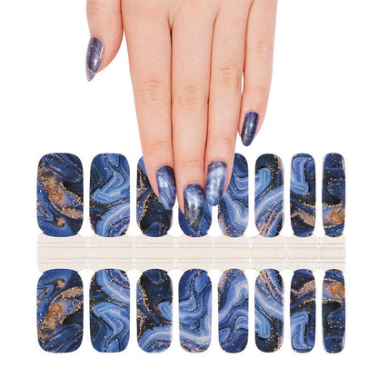 Navy nail wraps with swirling marble pattern and gold glitter flecks, glossy finish