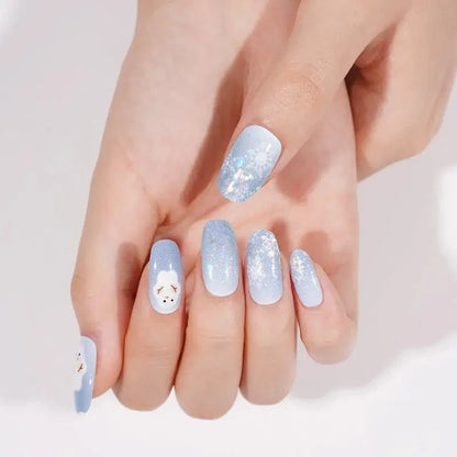 Festive blue gradient nail wraps with sparkly snowflakes and adorable snowman accent