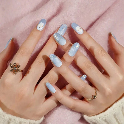 Blue glittery nail wraps with cute snowman faces displayed on hands, festive winter nail art