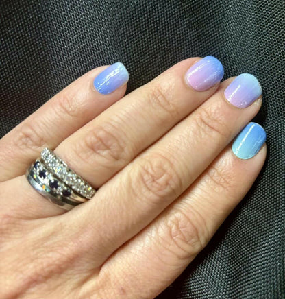 Blue gradient nail wraps applied on hand showing ombre manicure results