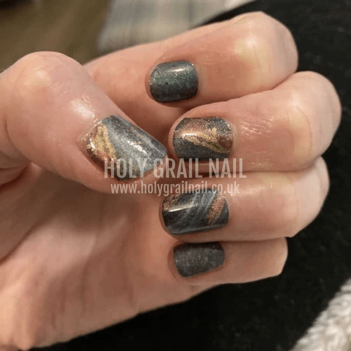 Grey shimmer Holy Classics nail wraps with bronze and gold swirled marble accents