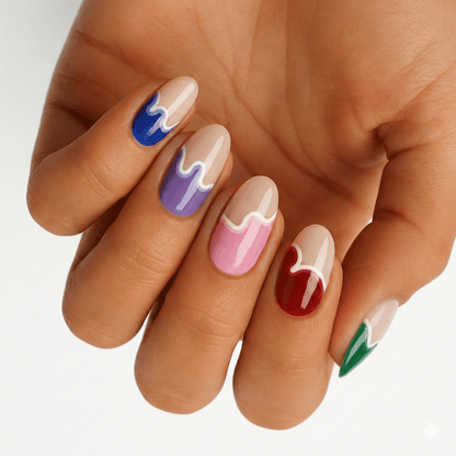 Multicoloured paint drip nail wraps on hand showing blue purple pink red green artistic design