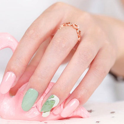 Pink and sage green nail wraps with a tropical palm leaf accent nail