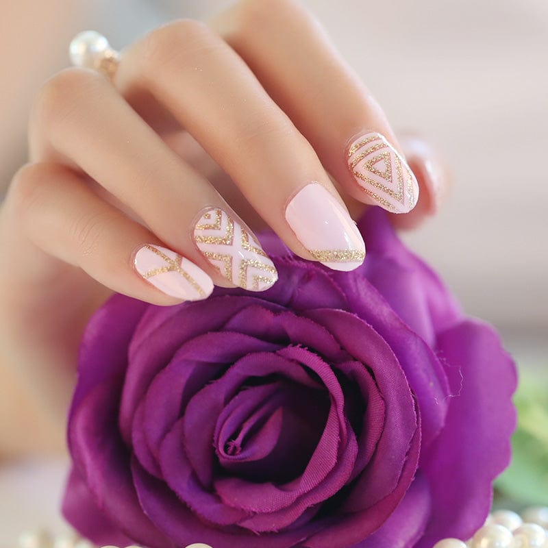 Pale pink nail wraps with gold glitter geometric chevron accent design