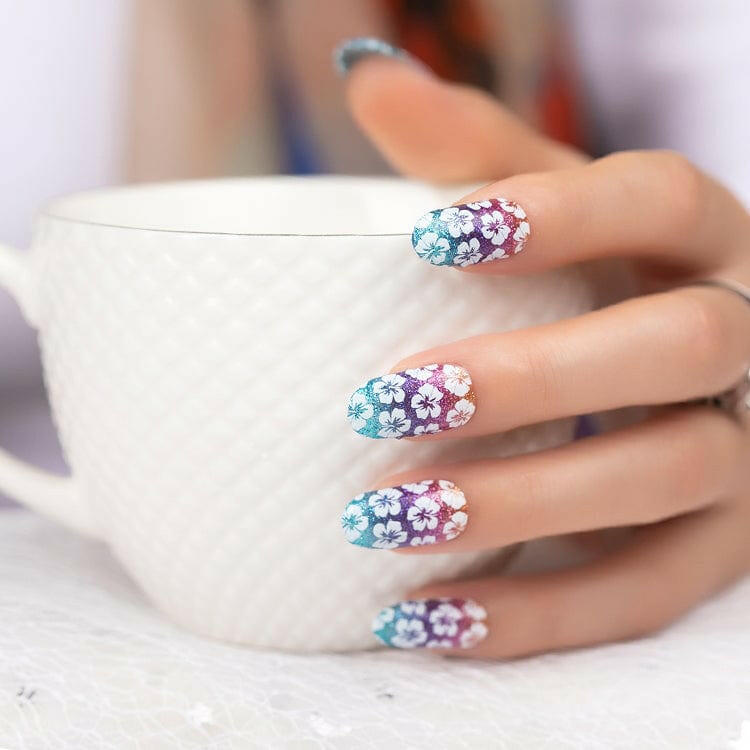 Holy Classics nail wraps, blue-to-purple ombré glitter with white hibiscus flower design