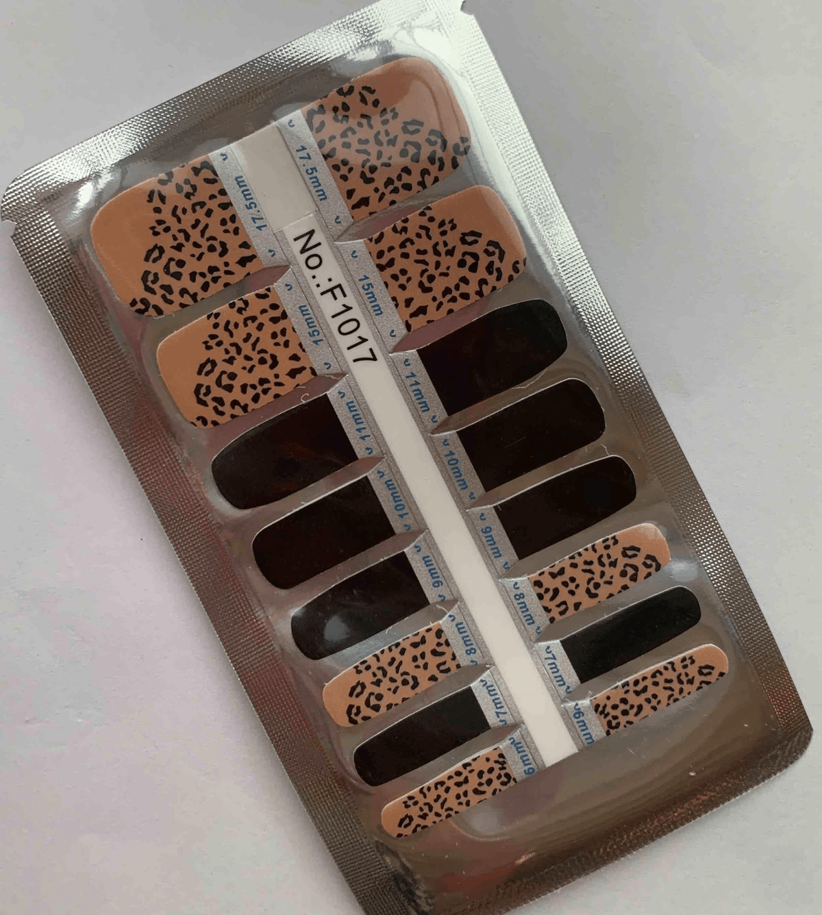 Non-UV pedicure nail wraps in leopard print pattern with nude base and black spots
