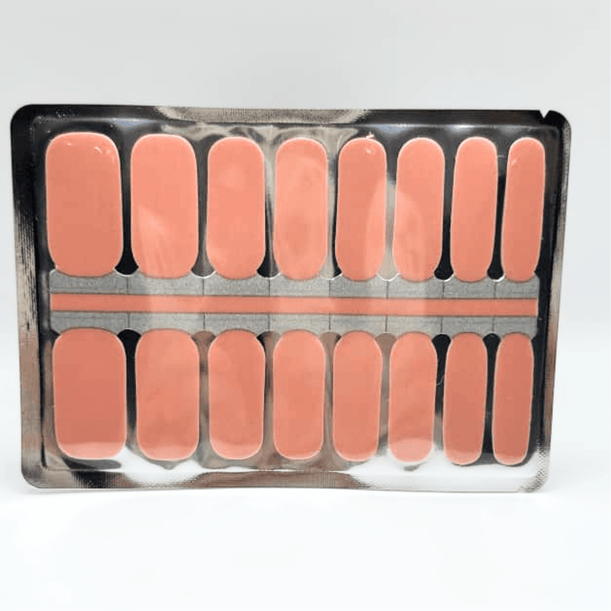 Solid peach-coral glossy Holy Classics non-UV nail wraps, shown on foil backing sheet.