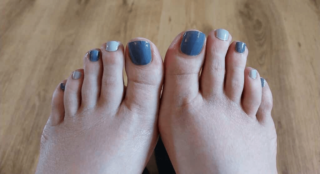 Grey pebble pedicure nail wraps on toes showing elegant matte finish at-home pedicure