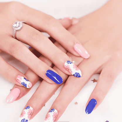 Pink and navy blue floral peony nail wraps on hand showing elegant botanical manicure design