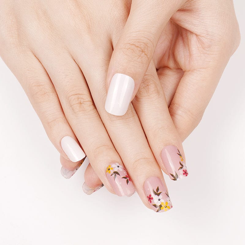 Pink floral nail wraps with delicate botanical pattern on hand showing feminine nail art design