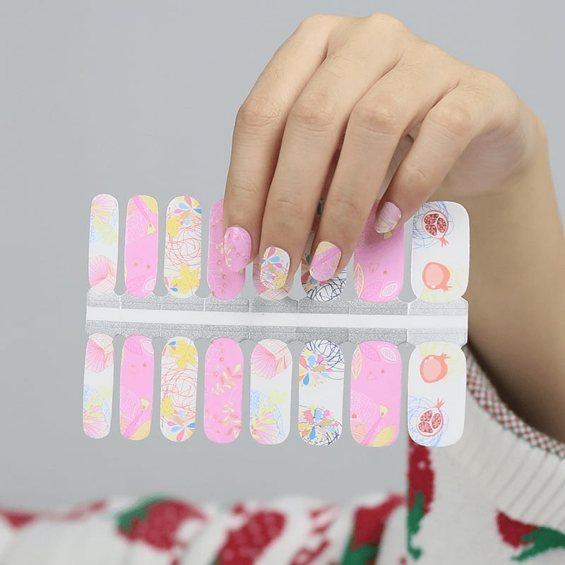 Non-UV nail wraps sheet showing pink botanical patterns and floral designs for manicure