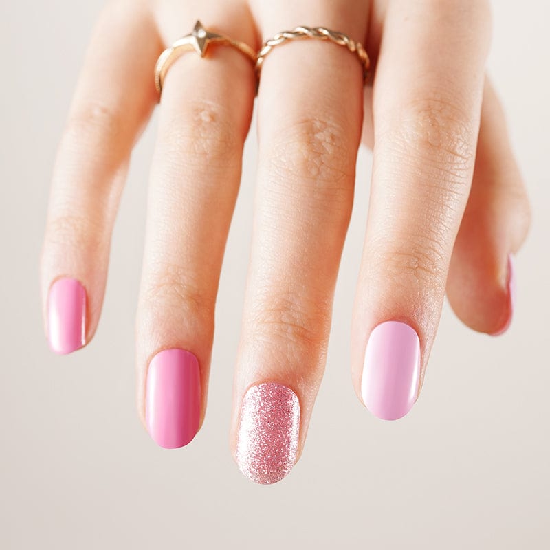 Glossy pink nail wraps with one glitter accent nail in rose-gold sparkle