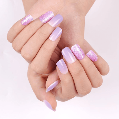 Hands showing purple and pink gradient nail wraps with glitter accent nails manicure