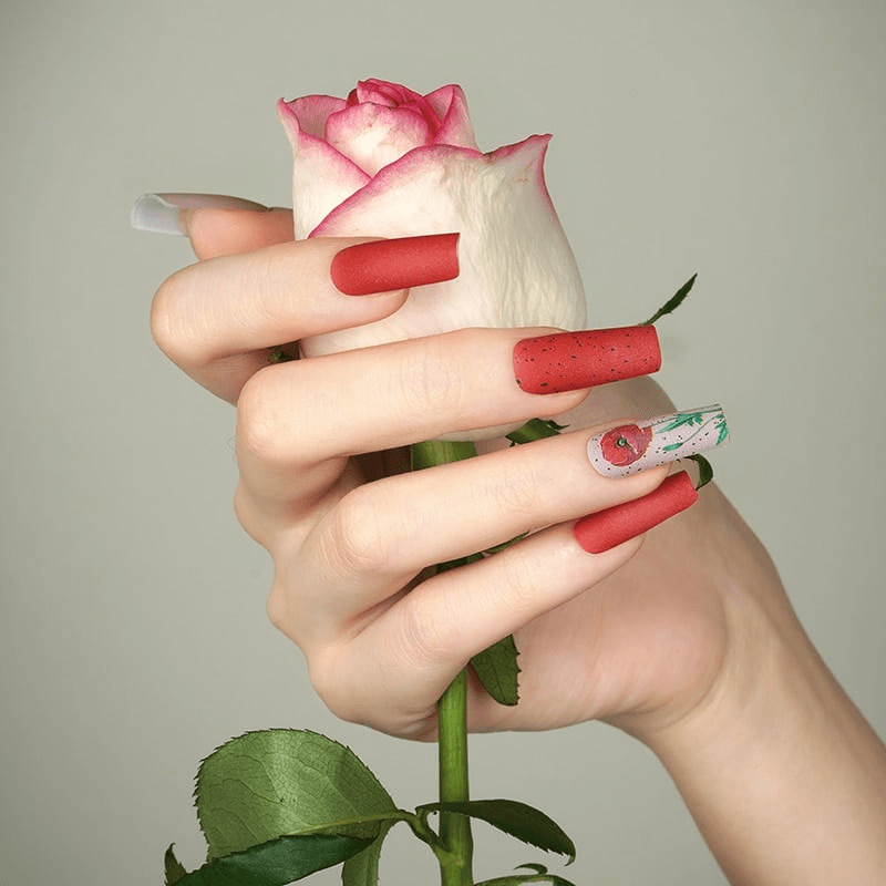 Matte red nail wraps, square tips, with black speckled and floral poppy accent nail