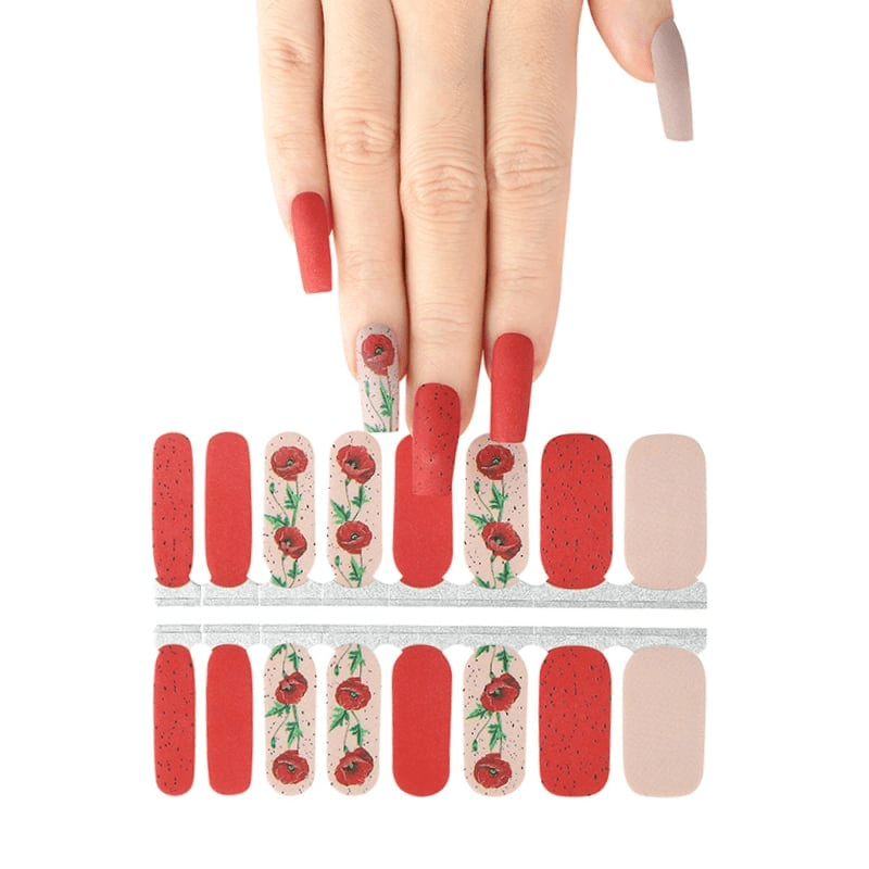 Red and cream floral nail wraps with poppy design displayed with hand model
