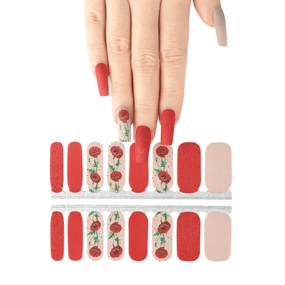 Red and cream floral nail wraps with poppy design displayed with hand model